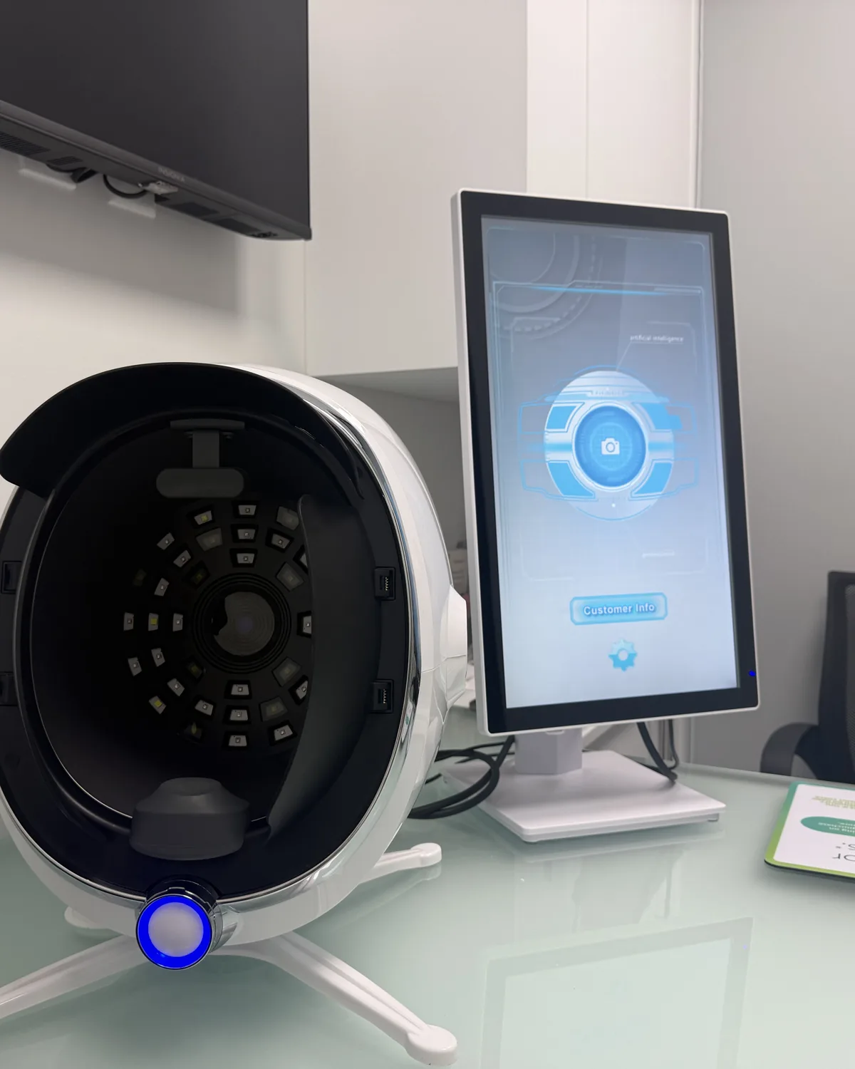 The skin analyzer and its results screen in a treatment room at AWE in Pinecrest
