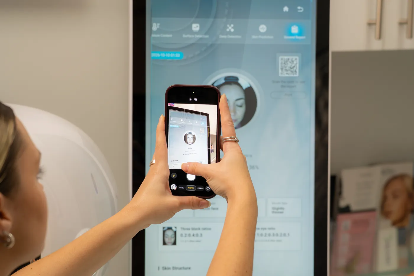 A guest scanning the code on the analyzer screen to take her report home on her phone